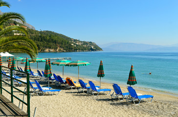 Fototapeta na wymiar Ipsos Beach in Corfu sun loungers