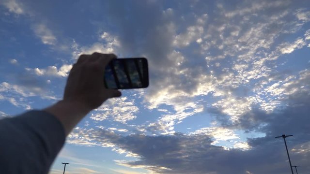 Point of view on the taking selfie photo on beautiful cloudscape in 4K Slow motion 60fps