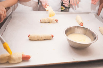 Young children make sausage dough. Hands closeup