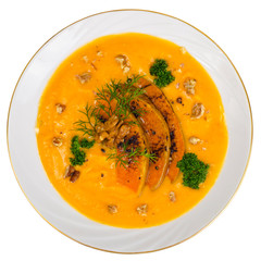 Vegetable soup puree with pumpkin and walnut on white background
