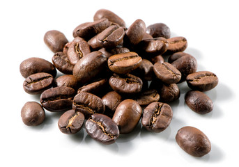 roasted coffee beans heap close-up on white background