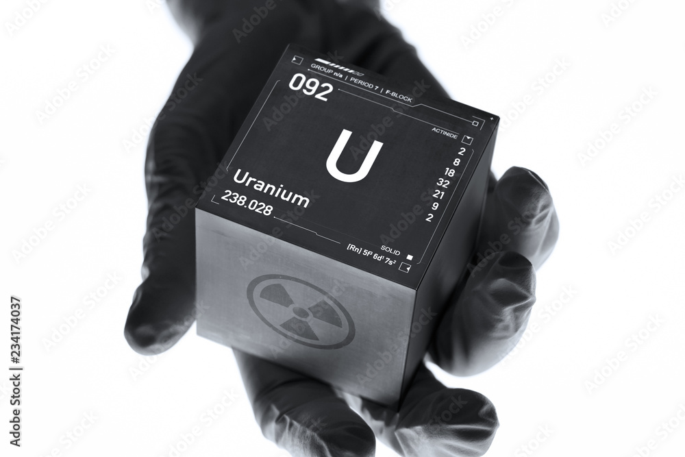 Poster uranium cube in the hand of a scientist. radioactive element from the periodic table.