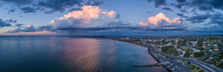 Frankston coastline with stormy clouds and rain - wide aerial panoramic landscape