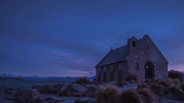 Church of the Good Shepherd in early morning before sunrise on the bank of Lake Tekapo surrounded by beautiful landscape of New Zealand. Major tourist attraction on the South Island. Timelapse video.