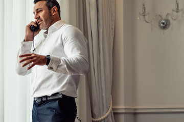 Businessman on trip working from hotel room
