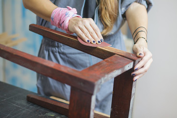 detail of woman restoring furniture