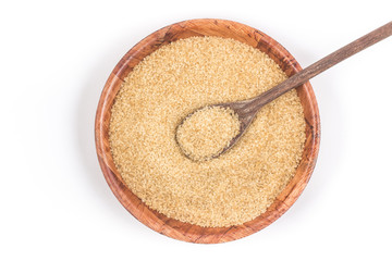 Demerara sugar in a wooden  bowl. Top view