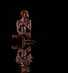 nude woman on a dark background