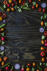Clean eating concept. Frame of fresh organic vegetables on wooden table. Top view with copy space 