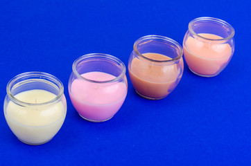 Multicolored aromatic decorative candles in glass