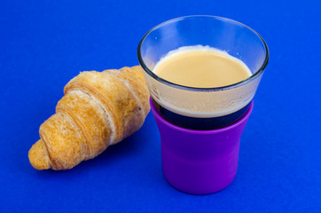 Black coffee in glass cup with croissant