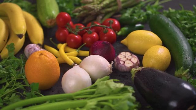a large set of organic, colorful and fresh vegetables on a black wooden table