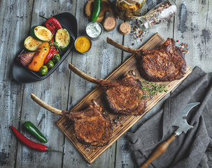 Grilled lamb,mutton meat chops with vegetables on a serving board. Rustic food concept