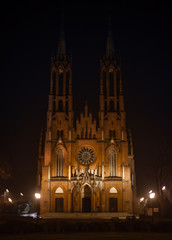 Fototapeta na wymiar Gothic medieval cathedral with central round window. Medieval church at night. Roman style window.