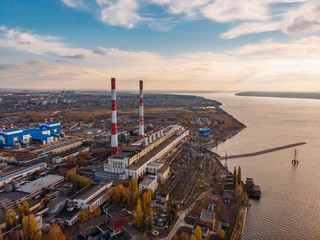 Aerial drone shot of thermal power plant and industrial zone at sunset