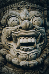 Closeup portrait of Hindu Buddhist traditional stone sculpture. Bali, Indonesia