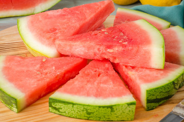 Slices of watermelon on a wood cutting board
