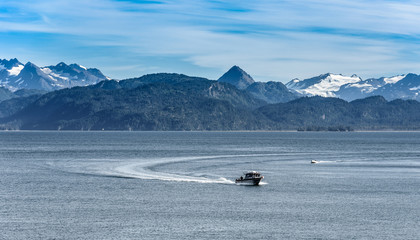 Fishing Boat in Front of Snow Capped Mountains in Seward Alaska