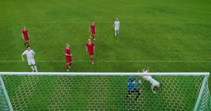 Soccer Player Receives Successful Pass, Kicks a Ball and Scores Amazing Goal doing Bicycle Kick, Goalkeeper Jumps but Fails to Save the Goals. Beautiful Aerial Shot Made from Behind the Goals.
