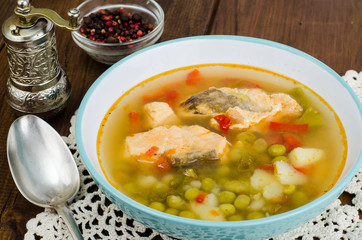 Bowl with salmon soup and fresh veggies