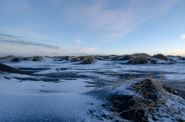Sunset over snowy frozen sand dunes