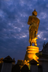 Great Golden Buddha statue at the"Wat Phra That Kao Noi" , Nan province, Thailand  with sky  Twilight time