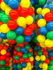 Fototapeta na wymiar Plastic colored balls in grid