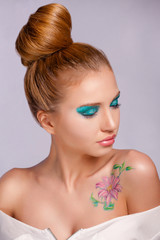 The nice girl closing eyes with the turned head in the right. Bright, spring make-up