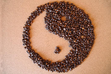 yin-yang coffee beans on wooden background