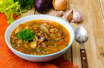 Hot vegetable soup with eggplants and lentils