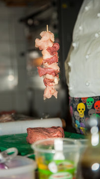 Kebab From Chicken In Mid Air - Raw Meat On Skewers