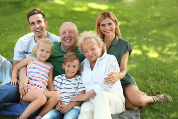 Fototapeta premium Couple with children and elderly parents in park