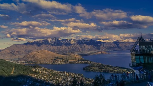 Timelapse of evening in Queenstown, New Zealand, observed from Gondola cable car top station. Shot from daylight through the sunset until the street lights turn on.