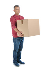 Full length portrait of mature man carrying carton box on white background. Posture concept