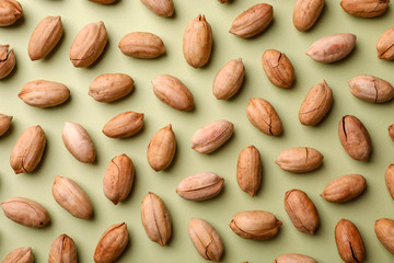 Composition with ripe pecan nuts on color background, flat lay