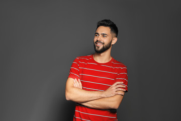 Portrait of handsome young man on gray background