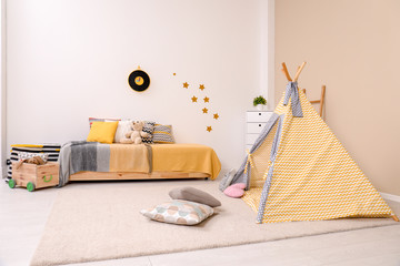 Cozy child room interior with bed, play tent and modern decor elements © New Africa
