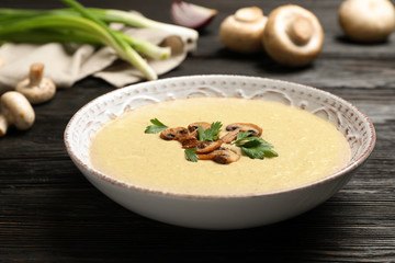 Bowl of fresh homemade mushroom soup on wooden table