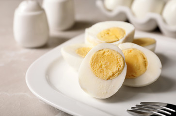 Plate with hard boiled eggs on table