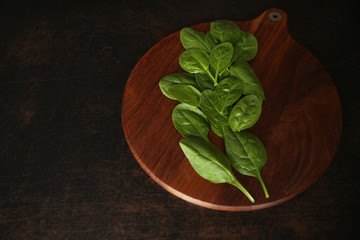green spinach on a wooden board