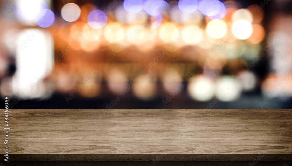 Aufkleber Wood table top with blur nightclub bar counter with bokeh light background,banner mock up for display of product or design content.