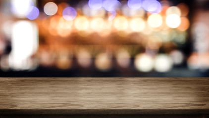 Wood table top with blur nightclub bar counter with bokeh light background,banner mock up for...