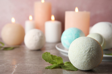 Fototapeta na wymiar Bath bombs and mint leaves on table. Space for text