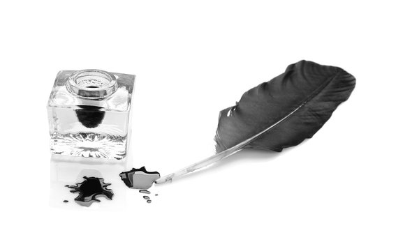 Feather pen and inkwell on white background