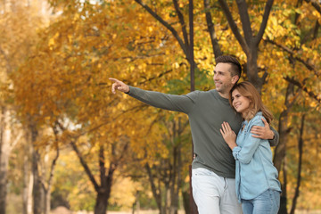 Happy lovely couple on walk in autumn park