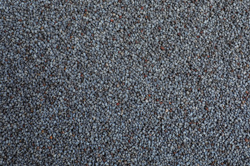 Whole poppy seeds as background, top view