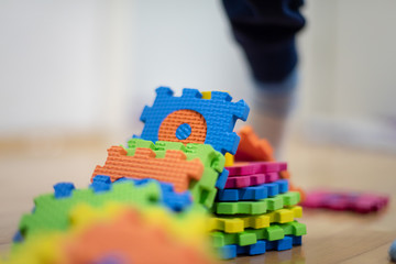 Preschooler child playing with colorful toy blocks. Kid playing with educational wooden toys.