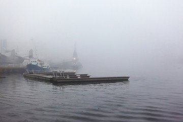 boat pier on the river in thick heavy fog