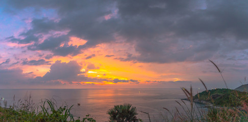 Fototapeta na wymiar panorama sunset at Laem Promthep Cape. The landmark and popular viewpoint of Phuket Thailand. in every day a lot of tourists come here to watching sunset..