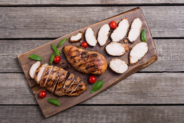 Grilled chicken breast ( fillet ) with basil and tomatoes